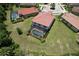 Aerial view of home with screened-in pool, lush green backyard, and neighboring houses in a well-maintained community at 20940 Valore Ct, Venice, FL 34293