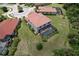 Aerial view of home with screened-in pool, lush green backyard, and neighboring houses in a well-maintained community at 20940 Valore Ct, Venice, FL 34293