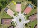 Aerial view of a home situated in a cul-de-sac with neighboring private pools at 20940 Valore Ct, Venice, FL 34293