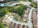 Aerial view of a house in a beautiful community with lush greenery, lakes and winding roads at 20940 Valore Ct, Venice, FL 34293