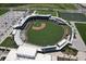 Aerial view of a well-maintained baseball field with green grass, seating, and parking, showcasing a recreational facility at 20940 Valore Ct, Venice, FL 34293