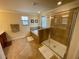 Bathroom featuring a soaking tub, glass enclosed shower, tile floors and vanity at 20940 Valore Ct, Venice, FL 34293
