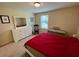 Well-lit bedroom with a large window, ample space, and neutral carpeting at 20940 Valore Ct, Venice, FL 34293