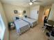 Bright bedroom featuring two twin beds, neutral walls, and a ceiling fan for a comfortable atmosphere at 20940 Valore Ct, Venice, FL 34293