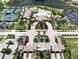 Community clubhouse with swimming pool, tennis courts, and landscaped grounds in a residential neighborhood at 20940 Valore Ct, Venice, FL 34293