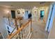 Wide second story hallway offering access to bedrooms and living spaces at 20940 Valore Ct, Venice, FL 34293