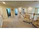 Bright and airy second story hallway with open access to various bedrooms and bathrooms at 20940 Valore Ct, Venice, FL 34293