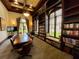 An elegant library featuring custom built in bookshelves, a large conference table, and comfortable seating at 20940 Valore Ct, Venice, FL 34293