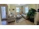 Cozy living room features neutral furniture, natural light, and tile floors, creating a welcoming space at 20940 Valore Ct, Venice, FL 34293