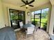 Covered patio with dining furniture, grill, lush backyard views offering great outdoor relaxation at 20940 Valore Ct, Venice, FL 34293