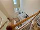 View of the foyer and living spaces from the carpeted second story staircase at 20940 Valore Ct, Venice, FL 34293