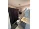 Bathroom featuring patterned wallpaper, a vanity with sink, and a shower with curtain at 2200 E Village Ct, Venice, FL 34293