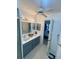 Bathroom features a double sink vanity with lots of lighting, ceiling fan, and tiled floors at 2200 E Village Ct, Venice, FL 34293