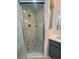 Bathroom features a shower with white and gray accent tile, plus a modern vanity and sink at 2200 E Village Ct, Venice, FL 34293
