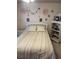 Bedroom featuring a double bed, light-colored carpet, and decoratively adorned walls at 2200 E Village Ct, Venice, FL 34293