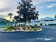 East Village Center clubhouse featuring colorful flowerbeds and well-manicured landscaping, enhancing its appeal at 2200 E Village Ct, Venice, FL 34293