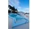 Inviting community pool with clear water, surrounded by palm trees, offering a relaxing recreational space at 2200 E Village Ct, Venice, FL 34293