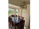 Dining room includes table with seating for six, view of yard through bright windows at 2200 E Village Ct, Venice, FL 34293