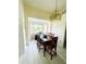 Formal dining room with seating for six, bright windows, and pendant lighting at 2200 E Village Ct, Venice, FL 34293