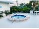 Relaxing community hot tub with stone surround and lush landscaping, providing a private and serene experience at 2200 E Village Ct, Venice, FL 34293