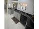 Bright kitchen with granite countertops and stainless steel sink, offering ample space at 2200 E Village Ct, Venice, FL 34293
