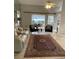 Bright living room with tile floors, plush seating, mirrored wall, and an open layout at 2200 E Village Ct, Venice, FL 34293