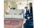 Bright living room with tile floors, plush seating, mirrored wall, and an open layout at 2200 E Village Ct, Venice, FL 34293