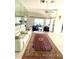 Bright living room with tile floors, plush seating, mirrored wall, and an open layout at 2200 E Village Ct, Venice, FL 34293