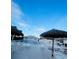 Community pool area with comfortable lounge chairs and shaded umbrellas, perfect for relaxation by the pool at 2200 E Village Ct, Venice, FL 34293