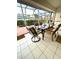 Sunroom featuring tile flooring, a glass dining table and chairs, and plenty of light at 2200 E Village Ct, Venice, FL 34293