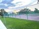 Community tennis courts with green fencing and manicured landscaping providing an active lifestyle option at 2200 E Village Ct, Venice, FL 34293