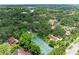 Aerial view of the property with lush trees and a tennis court on an expansive lot at 2237 Circlewood Dr # 18, Sarasota, FL 34231