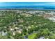 Wonderful aerial view of the community, surrounded by mature trees and landscaping, with water in the distance at 2237 Circlewood Dr # 18, Sarasota, FL 34231