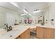 Bathroom with double vanity, marble countertop, and ample mirror space at 2237 Circlewood Dr # 18, Sarasota, FL 34231