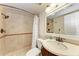 Bathroom with tiled shower and granite sink at 2237 Circlewood Dr # 18, Sarasota, FL 34231