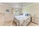 Bedroom features a bed with blue pillows and a ceiling fan at 2237 Circlewood Dr # 18, Sarasota, FL 34231
