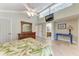 Bedroom featuring high ceilings, a TV, and an ensuite bathroom at 2237 Circlewood Dr # 18, Sarasota, FL 34231