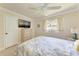 Bedroom with TV, ceiling fan, and light-colored furnishings at 2237 Circlewood Dr # 18, Sarasota, FL 34231