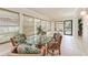 Bright dining area with a glass table, bamboo chairs and plentiful natural light coming through several windows at 2237 Circlewood Dr # 18, Sarasota, FL 34231