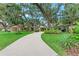 Inviting home featuring mature trees, a winding driveway, and lush landscaping, creating a serene setting at 2237 Circlewood Dr # 18, Sarasota, FL 34231