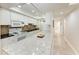 Well-lit kitchen featuring white cabinetry, granite countertops, and modern appliances, offering both style and functionality at 2237 Circlewood Dr # 18, Sarasota, FL 34231
