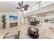 Bright living space boasting high ceilings, large windows, tile flooring, and an open layout to dining and kitchen at 2237 Circlewood Dr # 18, Sarasota, FL 34231
