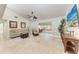 Bright living room featuring neutral décor, tiled floors, and a ceiling fan, creating a welcoming atmosphere at 2237 Circlewood Dr # 18, Sarasota, FL 34231