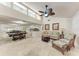 Open-concept living area showcasing tile flooring, ceiling fan, and a seamless transition to the dining and kitchen areas at 2237 Circlewood Dr # 18, Sarasota, FL 34231