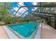Enclosed in-ground pool with a screened enclosure and ample lounging space in a private backyard oasis at 2237 Circlewood Dr # 18, Sarasota, FL 34231