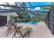 Enclosed pool area with lounge chairs and shaded seating, ideal for relaxing poolside at 2237 Circlewood Dr # 18, Sarasota, FL 34231