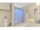 Bathroom featuring a shower with blue patterned shower curtain, toilet, and white vanity at 227 Monet Dr, Nokomis, FL 34275