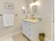 Bathroom featuring a white vanity, a framed mirror, and neutral tile flooring at 227 Monet Dr, Nokomis, FL 34275