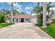 Charming home with a red tile roof and manicured lawn at 227 Monet Dr, Nokomis, FL 34275