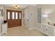 Inviting foyer with tile flooring, a decorative door, and stylish accents at 227 Monet Dr, Nokomis, FL 34275